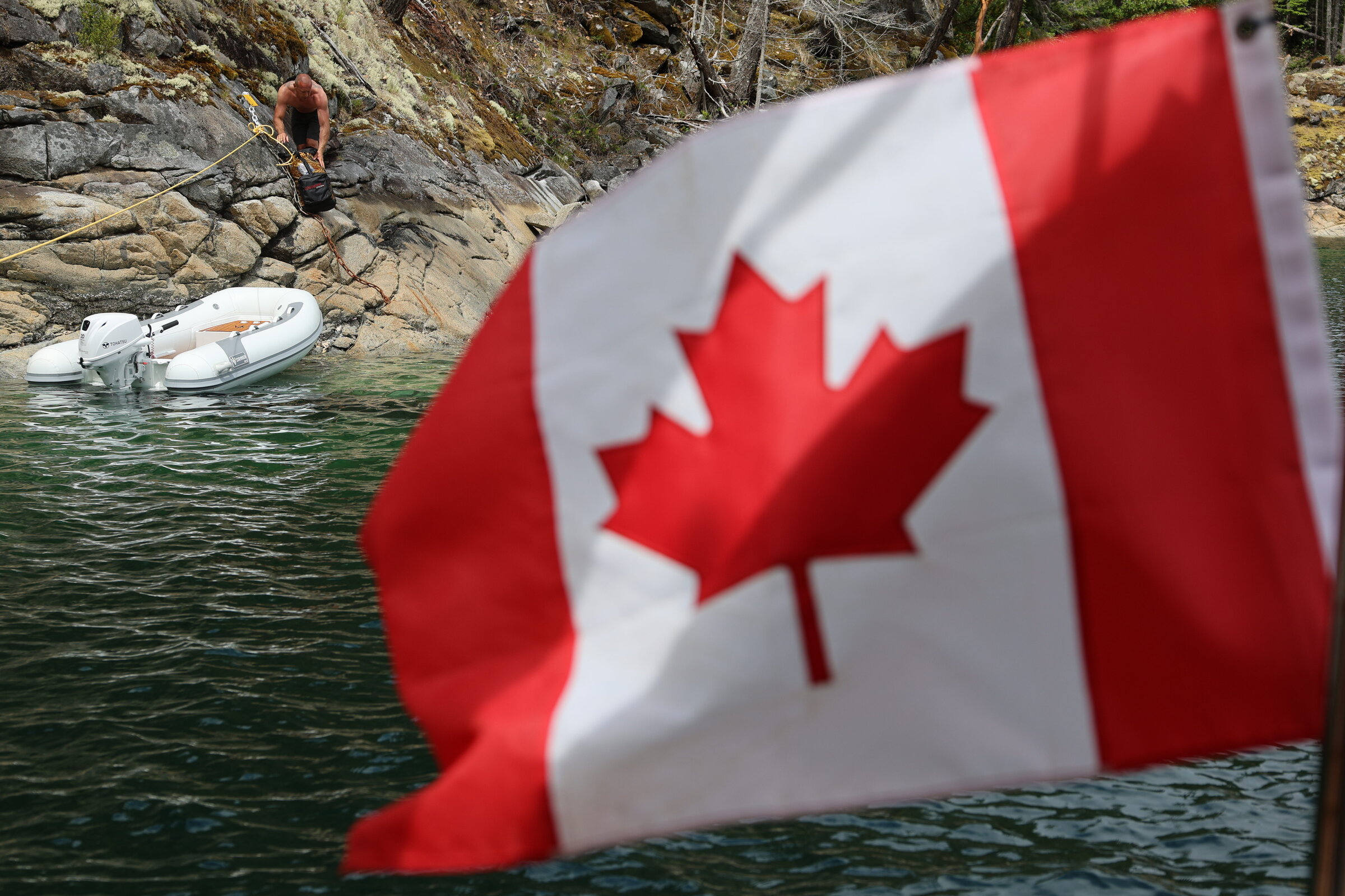 A Canadian flag flying near our stern-tied boat in Melanie Cove