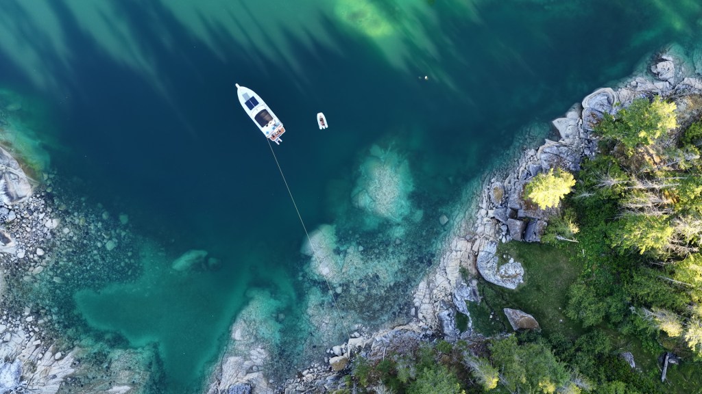 Aerial drone view of the stern-tied boat in Laura Cove