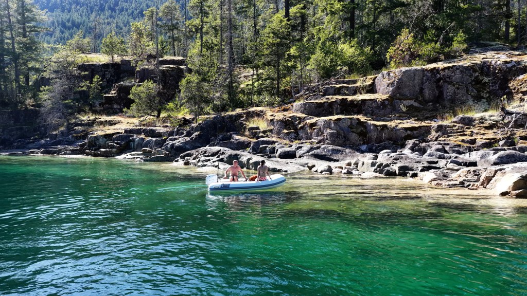 Aerial view of the boat entering Walsh Cove's emerald anchorage in Desolation Sound, BC