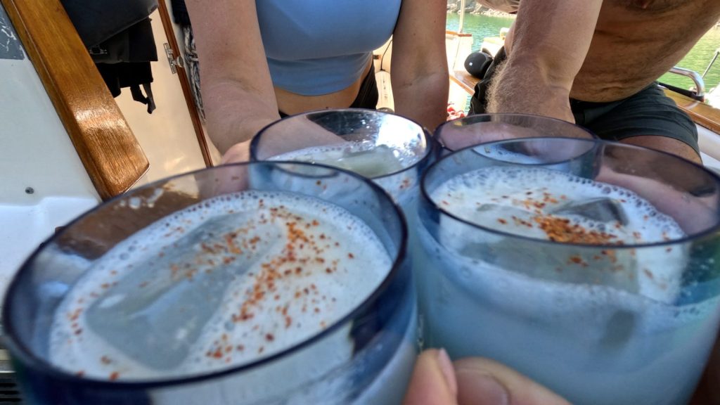 Cheers with drinks on the mothership in Melanie Cove