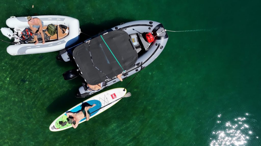 Overhead drone shot of the two Strykers and a paddleboard rafted up
